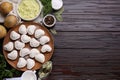 Raw dumplings (varenyky) and ingredients on brown wooden table, flat lay. Space for text Royalty Free Stock Photo