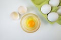 Raw egg bowl and eggs in a tray on a white Royalty Free Stock Photo