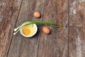 Raw egg in a bowl selective focus and onion on wooden table Royalty Free Stock Photo