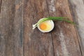 Raw egg in a bowl selective focus and onion on wooden table Royalty Free Stock Photo