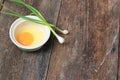 Raw egg in a bowl selective focus and onion on wooden table Royalty Free Stock Photo