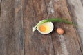 Raw egg in a bowl selective focus and onion on wooden table Royalty Free Stock Photo