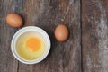 Raw egg in a bowl selective focus on wooden table Royalty Free Stock Photo