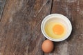 Raw egg in a bowl selective focus on wooden table Royalty Free Stock Photo