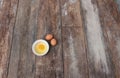 Raw egg in a bowl selective focus on wooden table Royalty Free Stock Photo