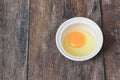 Raw egg in a bowl selective focus on wooden table Royalty Free Stock Photo