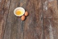 Raw egg in a bowl selective focus on wooden table Royalty Free Stock Photo