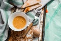 Raw egg broken into a white bowl with yolk and protein, next to the shell, fork and towel on a rusty metal background as at home i Royalty Free Stock Photo