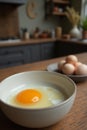 Raw egg in ceramic bowl on wooden kitchen counter with eggs in background Royalty Free Stock Photo