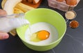 Raw Egg in Mixing Bowl Being Poured by Milk for Baking Banana Bread Pudding Royalty Free Stock Photo