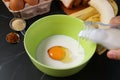 Raw Egg in Mixing Bowl Being Poured by Fresh Milk for Baking Banana Bread Pudding Royalty Free Stock Photo