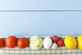 Raw egg, tomatoes, onion, garlic and lemon on wooden background. Uncooked ingredients for healthy breakfast. Top view Royalty Free Stock Photo