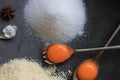 Raw egg yolk on a metal spoon. Ingredients for the cake: sugar, almond flour, cinnamon, eggs.