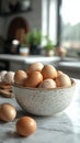 Raw eggs arranged in a ceramic bowl with morning light shining softly in a kitchen setting Royalty Free Stock Photo