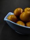 Raw eggs in a blue bowl isolated on a black - STOCK PHOTO Royalty Free Stock Photo