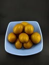 Raw eggs in a blue bowl isolated on a black - STOCK PHOTO Royalty Free Stock Photo