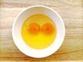 Raw eggs in bowl on the wooden table background with clipping pa Royalty Free Stock Photo