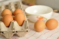 Raw eggs in box and egg yolk on plate Royalty Free Stock Photo