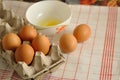 Raw eggs in box and egg yolk in plate