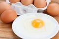 Raw eggs and broken one on plate Royalty Free Stock Photo