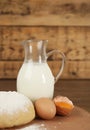 Raw eggs, dough and milk on table. Baking pie