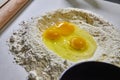 Raw Eggs in Flour for Pasta Prep on Countertop Royalty Free Stock Photo