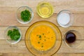 Raw eggs and ingredients on wooden background.