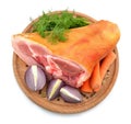 Raw Eisbein or ham hock, or Schweinshaxe on round board with wegetables. Royalty Free Stock Photo