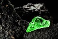 Raw emerald gem in rare stone mine, bright green stone Royalty Free Stock Photo