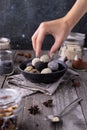 Raw energy bites balls prepared with natural ingredients on old rustic wooden background