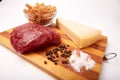 Raw Entrecote steak meat With Pepper and Salt pasta cheese On Wooden Board in a kitchen isolated on white