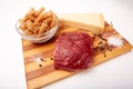 Raw Entrecote steak meat With Pepper and Salt pasta cheese On Wooden Board in a kitchen isolated on white