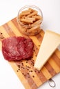 Raw Entrecote steak meat With Pepper and Salt pasta cheese On Wooden Board in a kitchen isolated on white