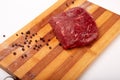 Raw Entrecote steak meat With Pepper and Salt On Wooden Board in a kitchen