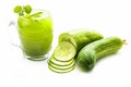 Raw extracted Cucumber juice in a transparent glass isolated on white along with raw fresh cucumber and slices,also. Royalty Free Stock Photo