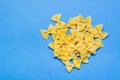 Raw farfale pasta on a blue cardboard background. Top view Royalty Free Stock Photo