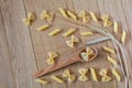 Raw farfalle and penne pasta on a wooden background. Top view ingredient of Italian cuisine Royalty Free Stock Photo