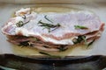 Raw fat pork meat seasoned with salt, papper, garlic and rosemary branches Royalty Free Stock Photo