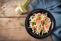 Raw fennel slices, grapefruit and red onions served as a healthy salad on a rustic wooden table, copy space, high angle view from Royalty Free Stock Photo