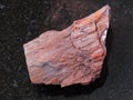raw ferruginous quartzite stone on dark