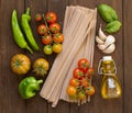 Raw fettucce pasta, vegetables and olive oil Royalty Free Stock Photo