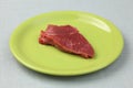 Raw fillet beef steak on a green plate Royalty Free Stock Photo