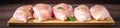 Raw fillet of chicken on a cutting board on a wooden table. Meat ingredients for cooking. Banner.