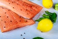 Raw fillet fresh salmon with pepper and lemon on wooden rustic background