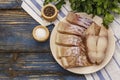 Raw fillet of saithe. Fresh slices on a plate, spices, parsley. A bunch of greens, vintage napkin Royalty Free Stock Photo