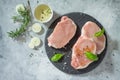 Raw fillet steak with rosemary, basil, onion and spices cooking on a stone kitchen table. Royalty Free Stock Photo