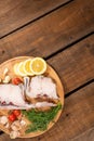 Raw fish cod on a tray, lemon tomato and pepper, wooden table in rustic style. Copy space Royalty Free Stock Photo