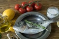 Raw fish cooking and ingredients. Dorado, lemon, herbs and spices.