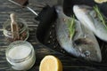 Raw fish cooking and ingredients. Dorado, lemon, herbs and spices.