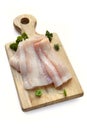 Raw Fish Fillets on Board over White Royalty Free Stock Photo